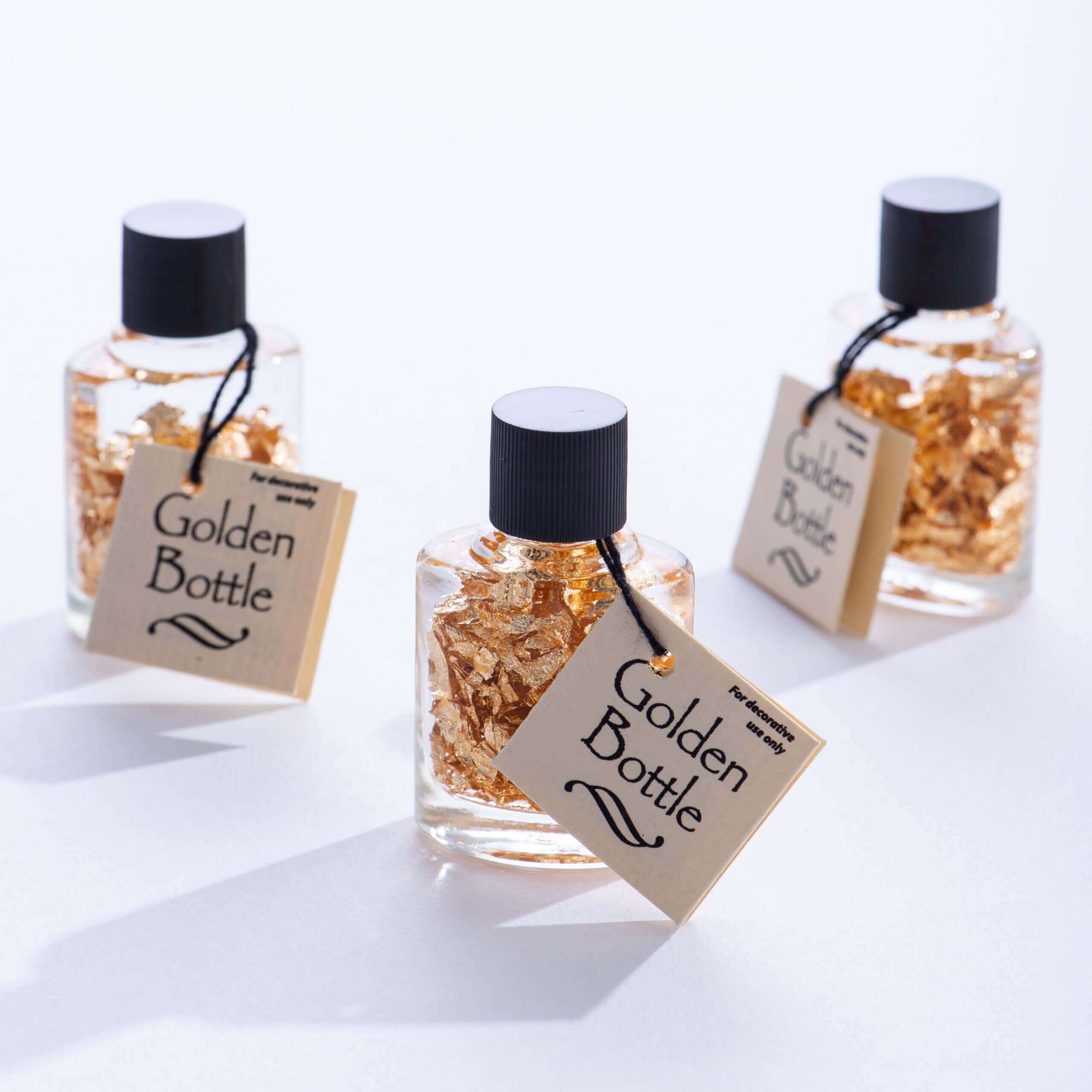 Bottles of Gold Flakes by GeoCentral scaled