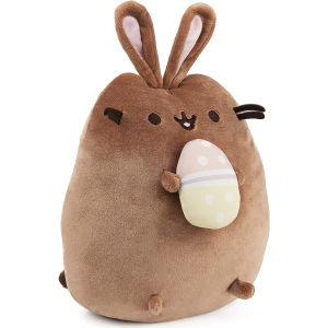 brown cuddly stuffed animal cat name Pusheen with bunny ears and holding an easter egg